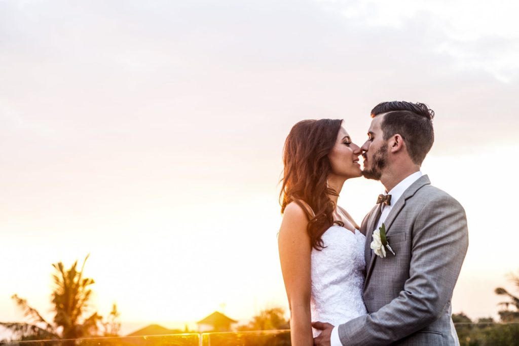 Balinese Temple and Garden Wedding - sunset background kiss