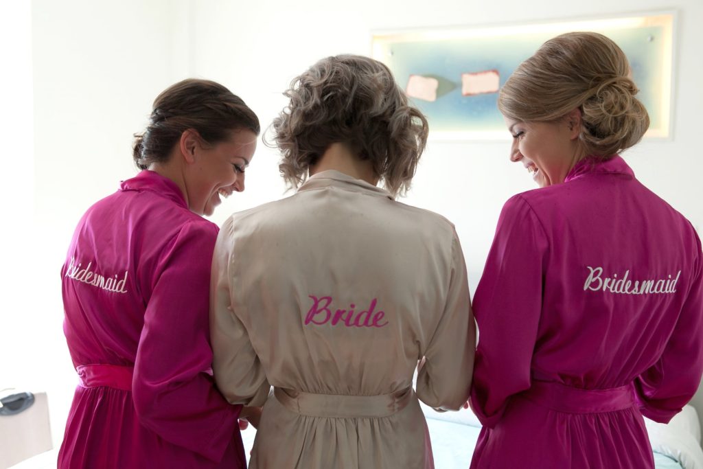 Beachfront Wedding - Bride and Bridesmaid preparing the wedding dress - getting married bali